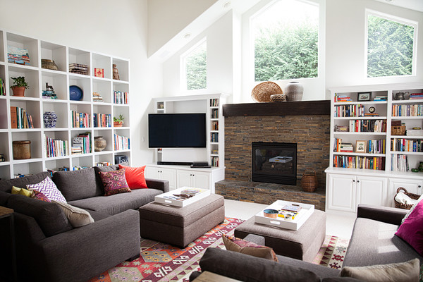 Inspiration for a mid-sized eclectic open concept living room in Other with white walls, carpet, a standard fireplace, a stone fireplace surround and a wall-mounted tv.