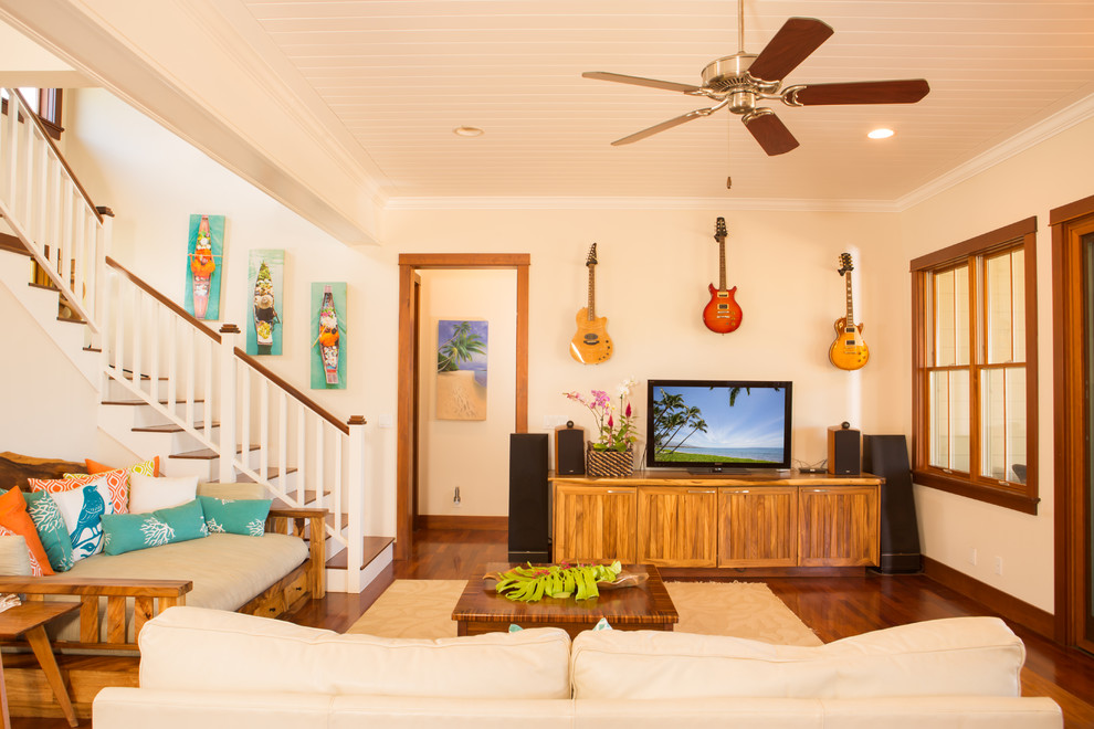 This is an example of a mid-sized tropical open concept living room in Hawaii with white walls and medium hardwood floors.