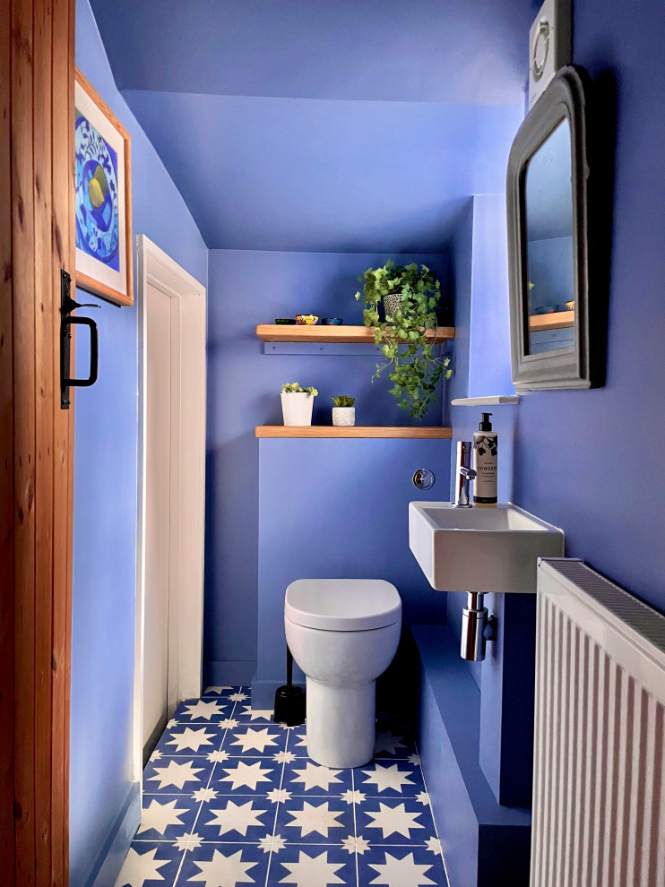 Photo of a mediterranean powder room in Oxfordshire with cement tiles and blue floor.