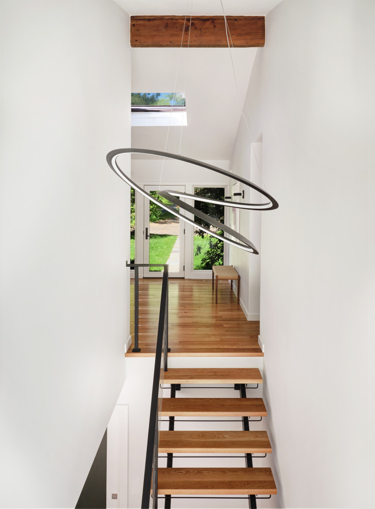 Inspiration for a mid-sized modern wooden straight open and metal railing staircase remodel in New York