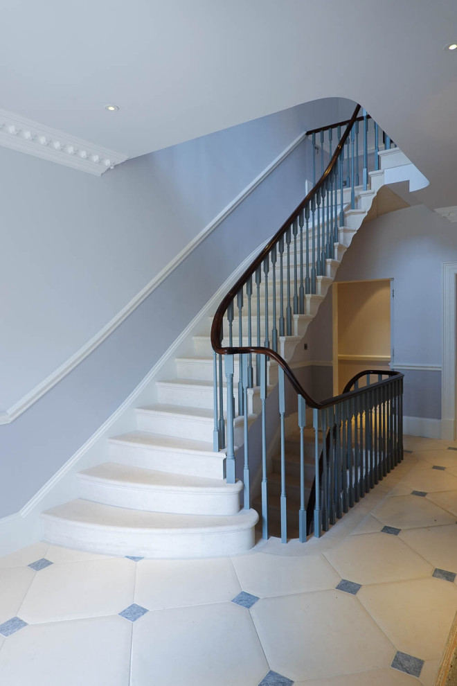 Inspiration for a traditional limestone curved staircase in Other with limestone risers and wood railing.