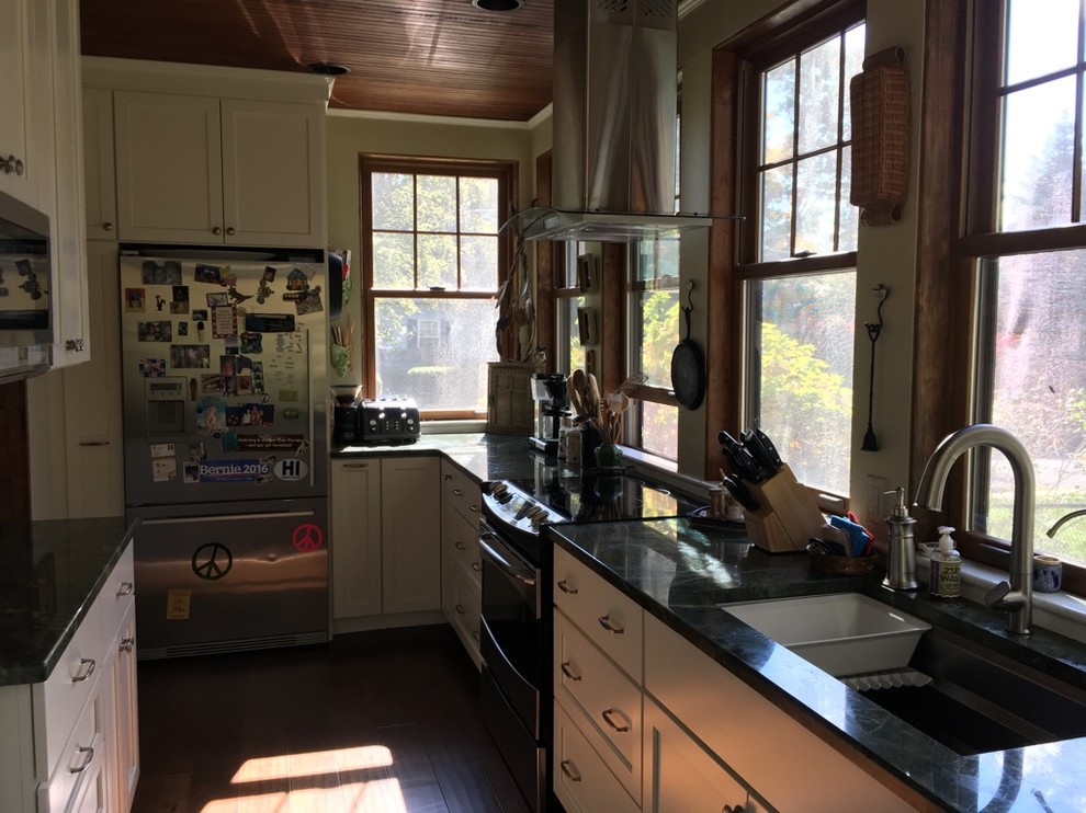 Example of a transitional u-shaped dark wood floor kitchen design in Boston with an undermount sink, shaker cabinets, white cabinets, granite countertops and stainless steel appliances