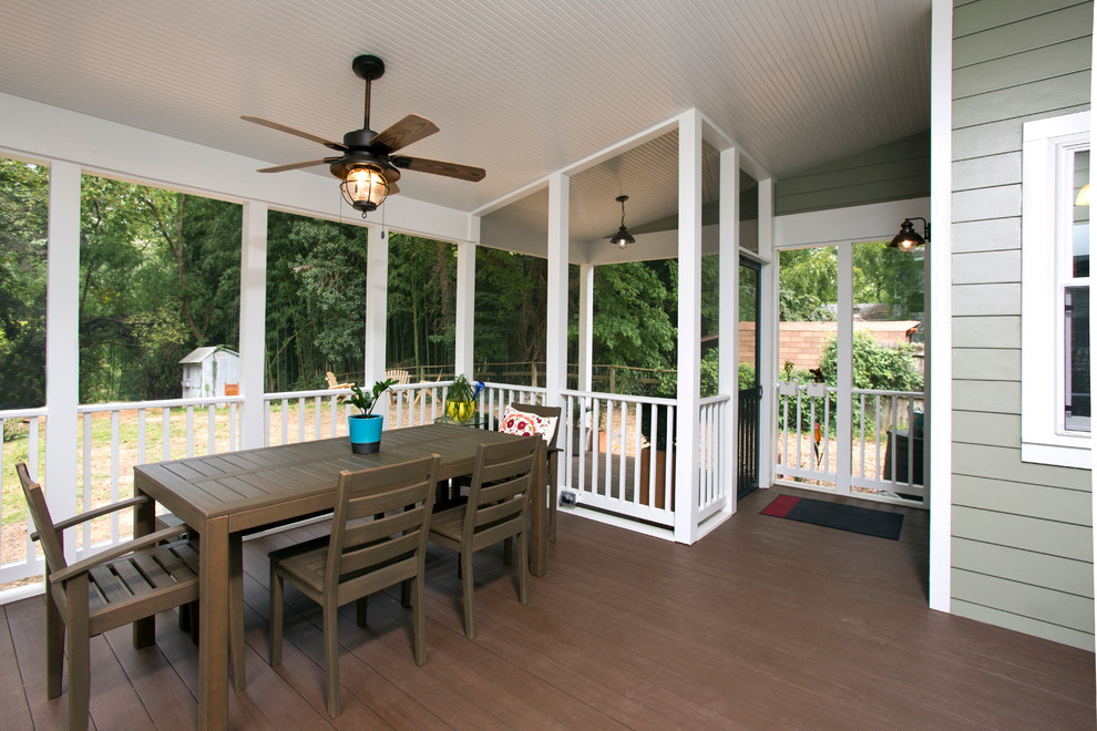 Photo of a transitional backyard screened-in verandah in DC Metro with decking and a roof extension.