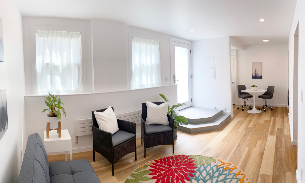 Example of a mid-sized minimalist enclosed laminate floor family room design in San Francisco with white walls