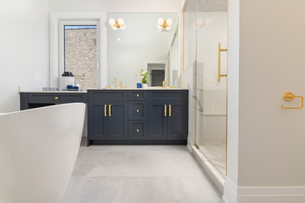 Large transitional master double-sink freestanding bathtub photo in Chicago with shaker cabinets, blue cabinets, a hinged shower door, white countertops and a built-in vanity