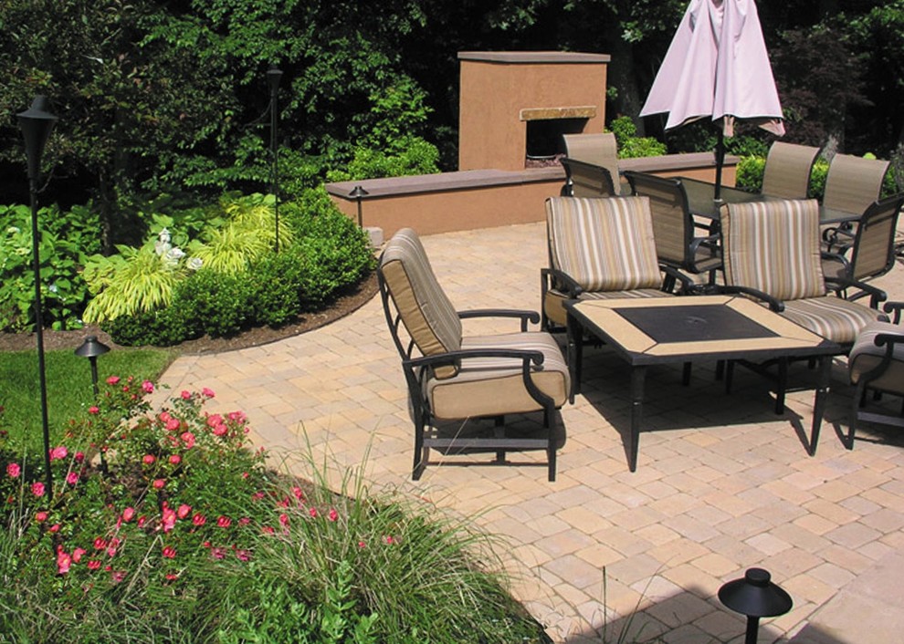 This is an example of a mid-sized traditional backyard patio in Providence with a fire feature and brick pavers.