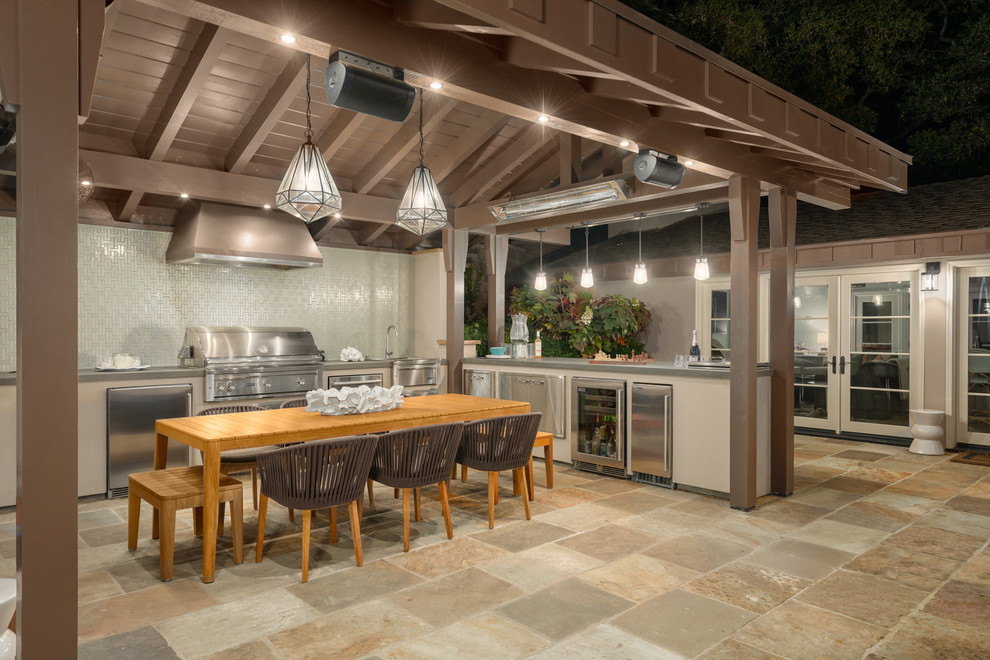 This is an example of a mid-sized transitional side yard patio in San Francisco with an outdoor kitchen, natural stone pavers and a gazebo/cabana.