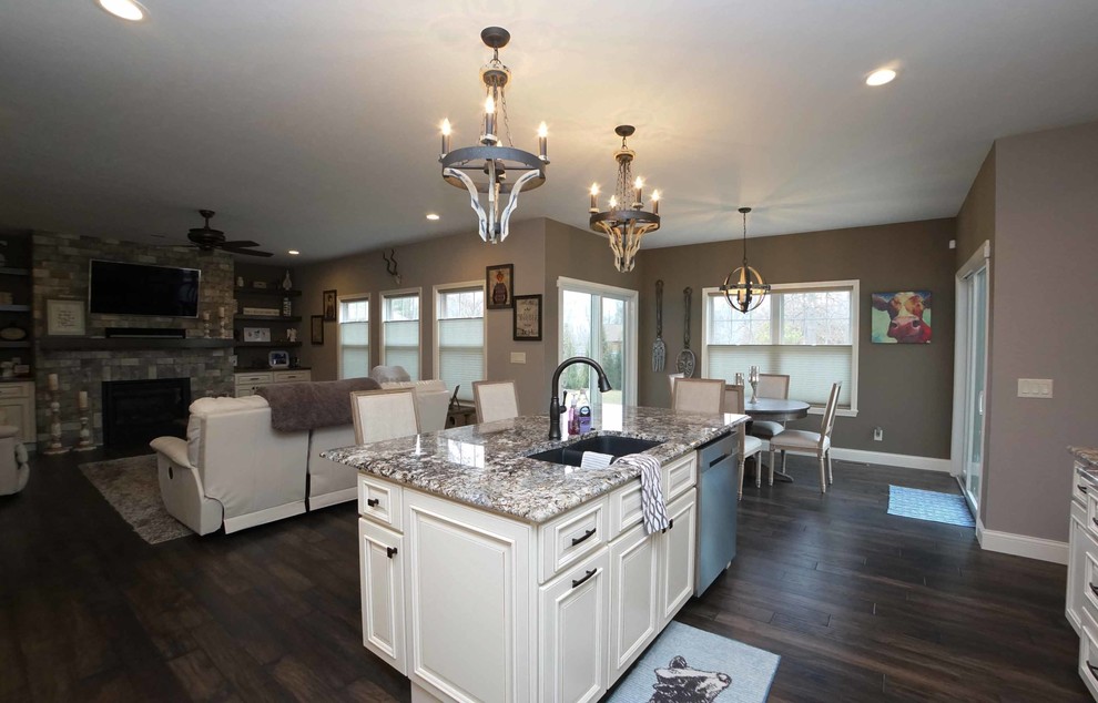 Open concept kitchen - mid-sized transitional dark wood floor and brown floor open concept kitchen idea in Chicago with a double-bowl sink, beaded inset cabinets, white cabinets, granite countertops, stainless steel appliances and an island