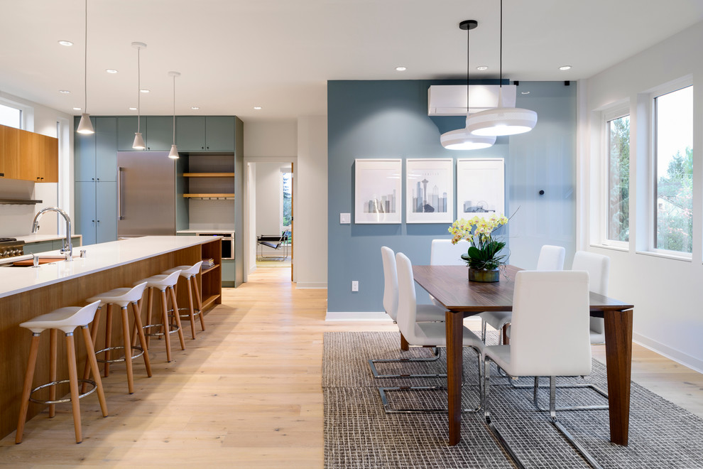 Mid-sized contemporary kitchen/dining combo in Seattle with blue walls, light hardwood floors and beige floor.