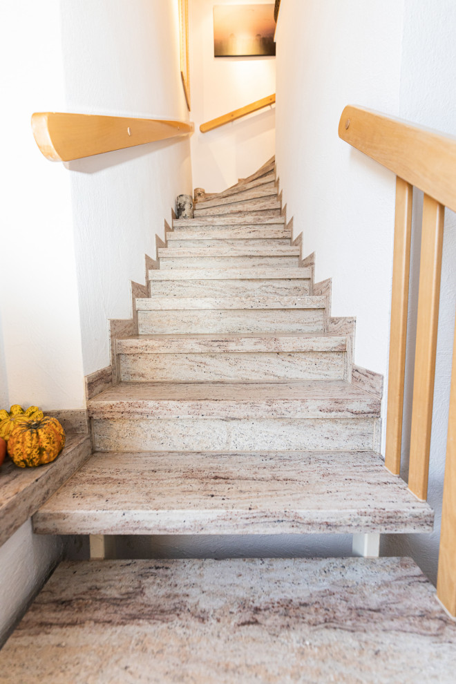 Design ideas for a mid-sized traditional marble l-shaped staircase in Other with wood railing.