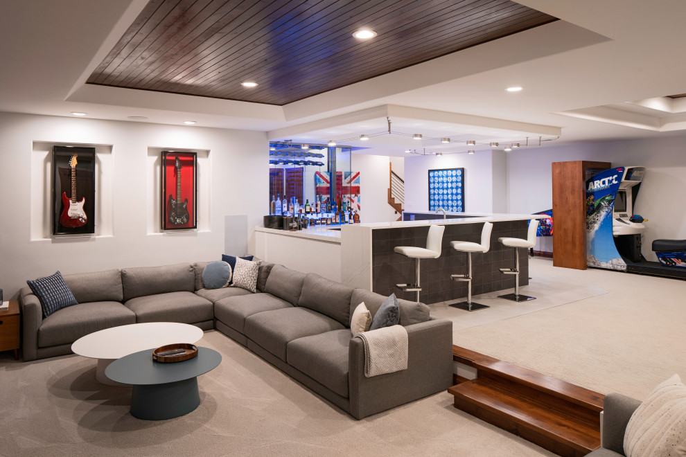 Inspiration for a large contemporary fully buried basement in Denver with a home bar, white walls, carpet, beige floor and recessed.