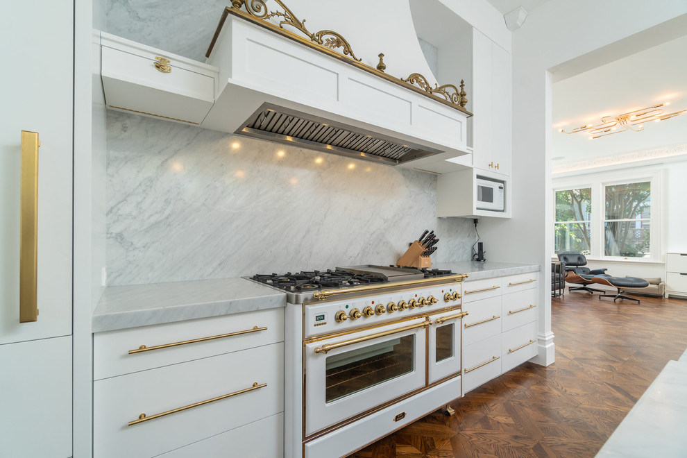 Design ideas for a traditional kitchen in San Francisco with recessed-panel cabinets, marble benchtops, white splashback, marble splashback, medium hardwood floors, with island and white benchtop.
