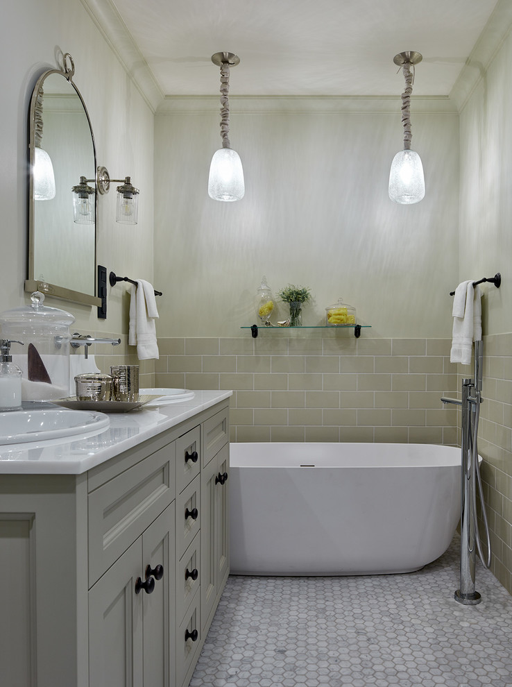 Photo of a mid-sized contemporary master bathroom in Moscow with recessed-panel cabinets, a freestanding tub, a drop-in sink, grey cabinets, marble floors, marble benchtops, beige tile and beige walls.