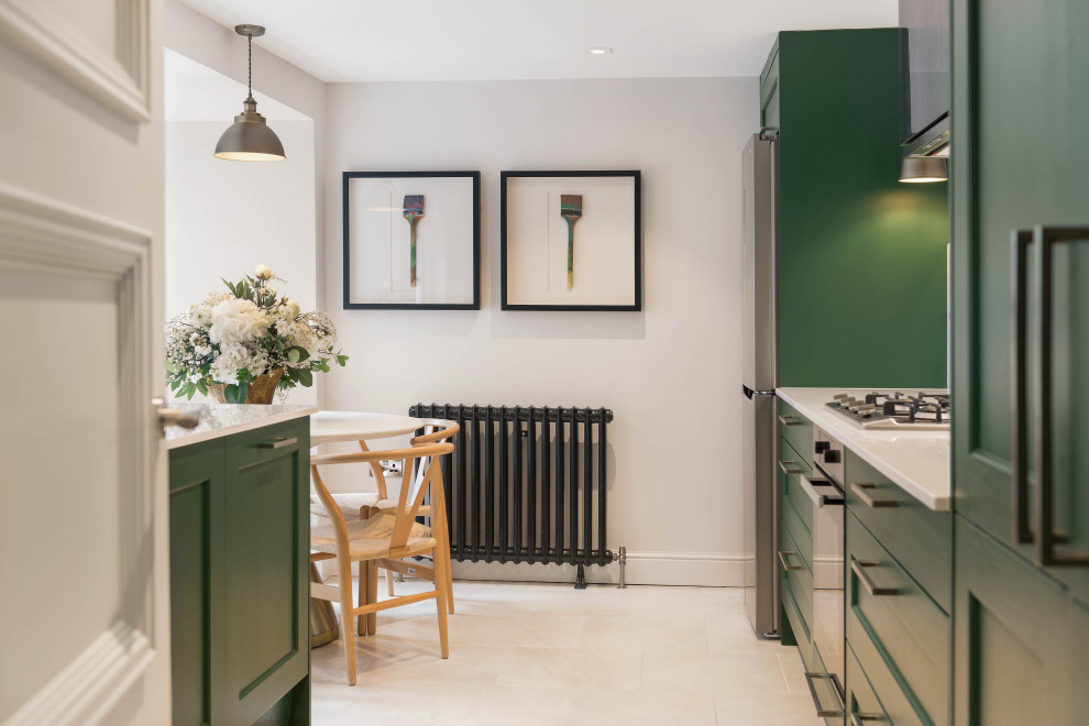 ロンドンにあるお手頃価格の中くらいなトランジショナルスタイルのおしゃれなキッチン (ダブルシンク、落し込みパネル扉のキャビネット、緑のキャビネット、珪岩カウンター、グレーのキッチンパネル、大理石のキッチンパネル、シルバーの調理設備、セラミックタイルの床、アイランドなし、ベージュの床、白いキッチンカウンター) の写真