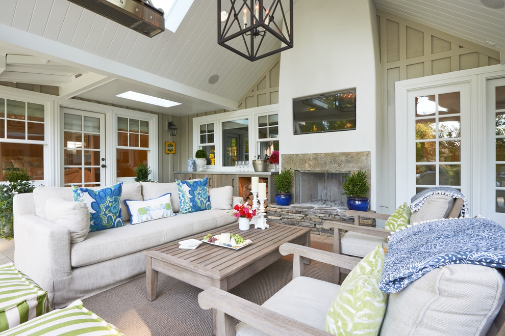 Inspiration for a beach style patio in Portland with a roof extension and with fireplace.