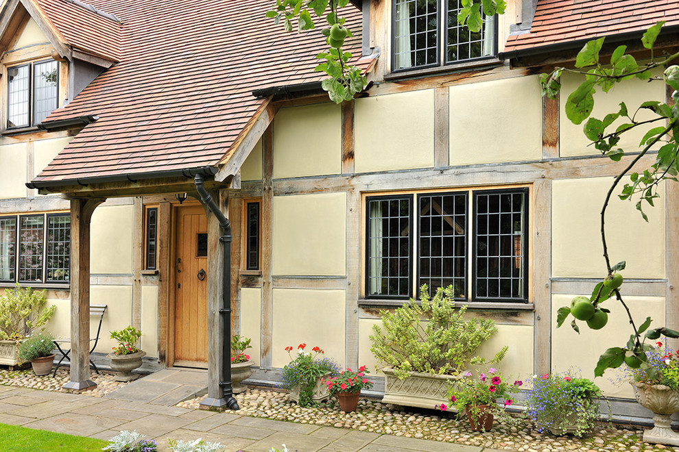 Design ideas for a traditional house exterior in Wiltshire with a tile roof and a gable roof.