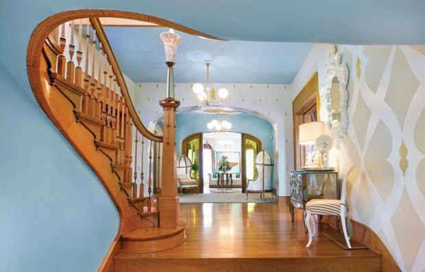 This is an example of an expansive traditional entryway in Columbus with multi-coloured walls and light hardwood floors.