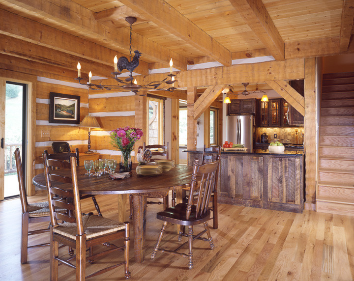 This is an example of a large country open plan dining in Charlotte with medium hardwood floors.