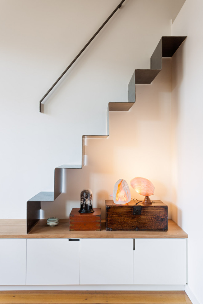 Inspiration for a small modern metal floating staircase in Melbourne with metal risers and metal railing.