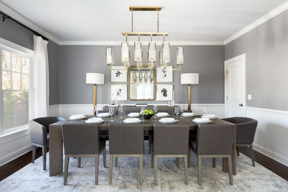Inspiration for a large transitional separate dining room in New York with grey walls, medium hardwood floors, brown floor and decorative wall panelling.