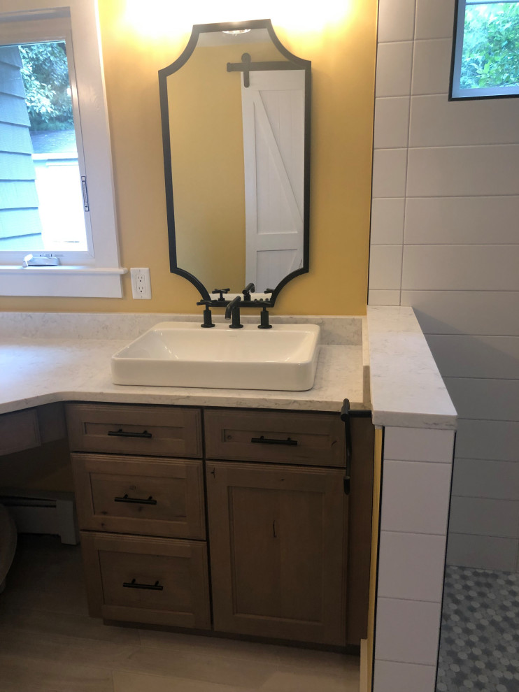 Inspiration for a mid-sized traditional powder room in Boston with shaker cabinets, black cabinets, grey walls, porcelain floors, an undermount sink, granite benchtops, multi-coloured floor and grey benchtops.