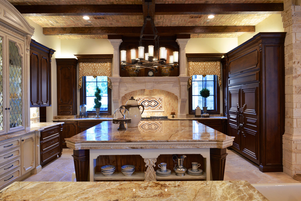 Photo of a large traditional u-shaped open plan kitchen in Dallas with recessed-panel cabinets, dark wood cabinets, granite benchtops, beige splashback, stone tile splashback, stainless steel appliances, limestone floors and multiple islands.
