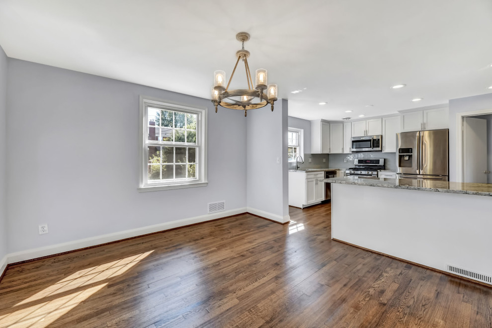 Large traditional kitchen/dining combo in Baltimore with grey walls, medium hardwood floors and brown floor.