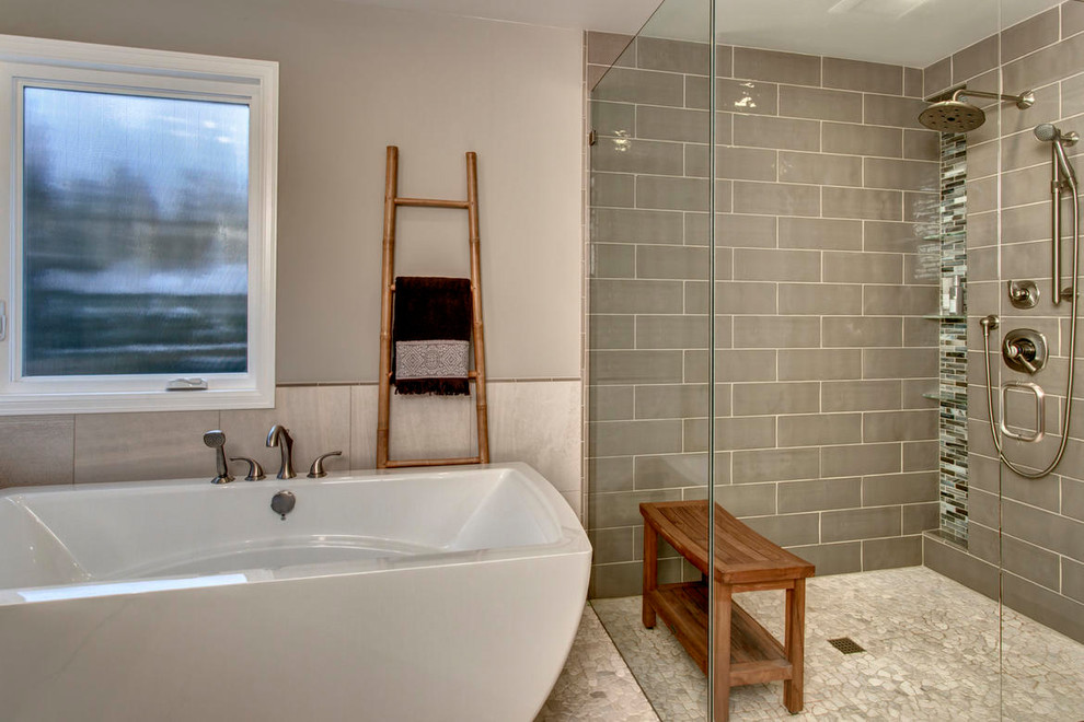Example of a large transitional master multicolored tile and matchstick tile pebble tile floor freestanding bathtub design in Seattle with shaker cabinets, dark wood cabinets, a two-piece toilet, beige walls, an undermount sink and quartz countertops