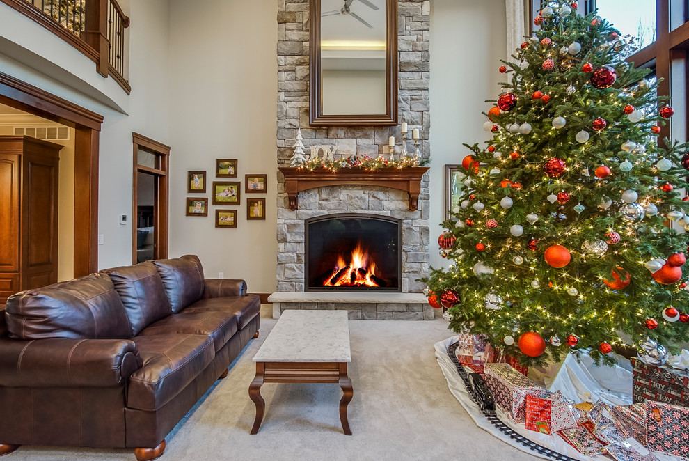 This is an example of a mid-sized traditional formal open concept living room in Grand Rapids with beige walls, a standard fireplace, a stone fireplace surround, grey floor and carpet.