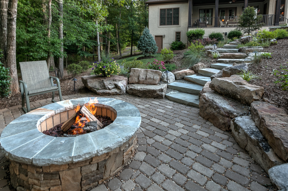Inspiration for a mid-sized country backyard patio in Charlotte with concrete pavers.