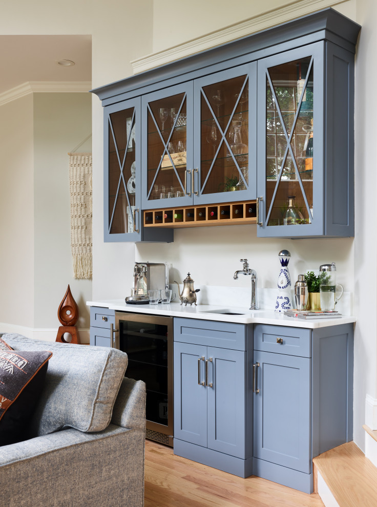 Country single-wall home bar in Boston with an undermount sink, shaker cabinets, blue cabinets, medium hardwood floors, brown floor and white benchtop.