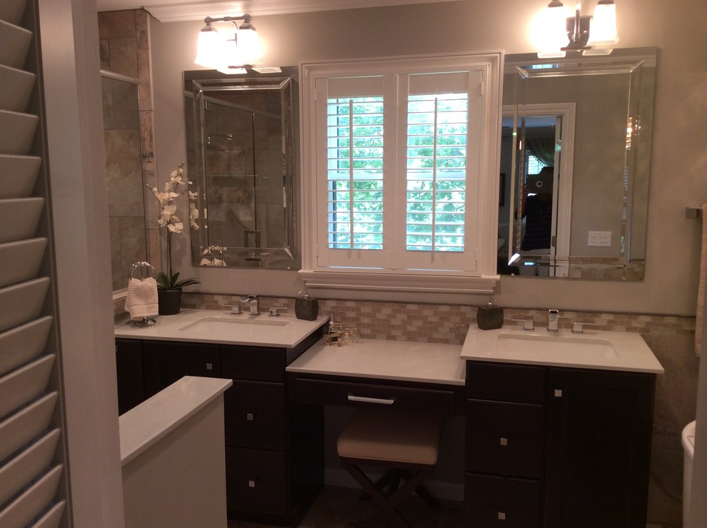Freestanding bathtub - mid-sized transitional master beige tile and ceramic tile ceramic tile freestanding bathtub idea in Birmingham with an undermount sink, flat-panel cabinets, dark wood cabinets, marble countertops, a two-piece toilet and beige walls