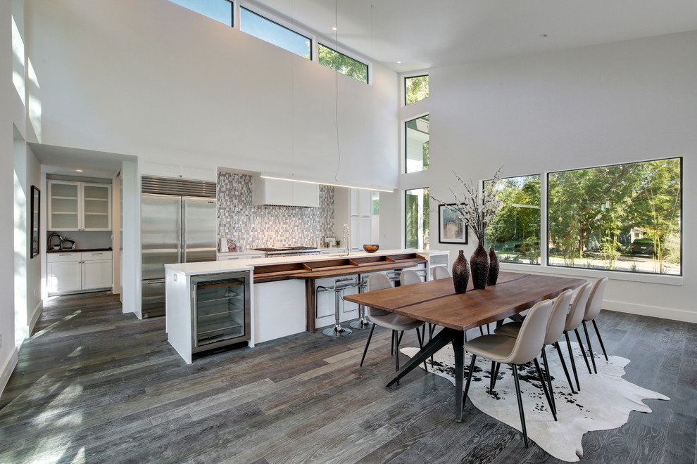 Design ideas for a contemporary eat-in kitchen in Austin with an undermount sink, white cabinets, multi-coloured splashback, mosaic tile splashback, stainless steel appliances, dark hardwood floors and with island.
