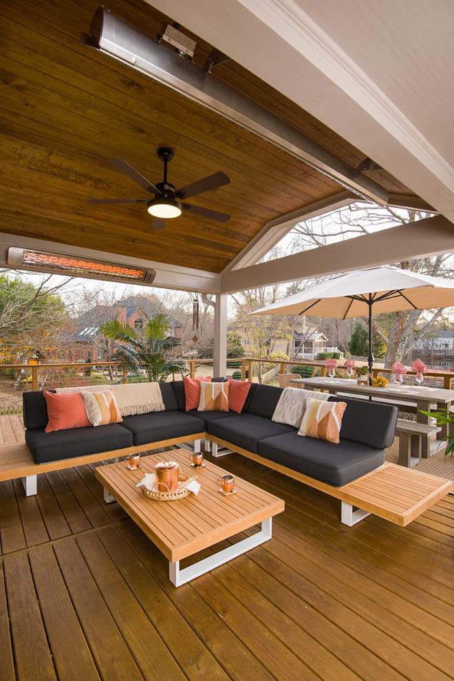 Cette photo montre un porche d'entrée de maison arrière tendance de taille moyenne avec une extension de toiture et un garde-corps en câble.