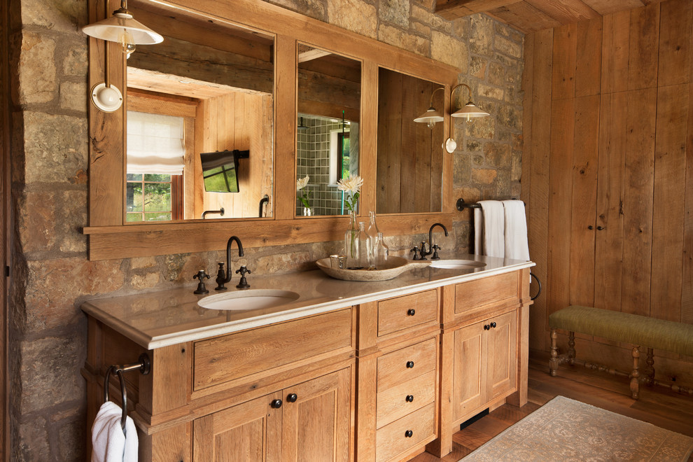 Inspiration for a large country master bathroom in Denver with medium hardwood floors, an undermount sink, medium wood cabinets, raised-panel cabinets, an alcove shower, green tile, ceramic tile and marble benchtops.