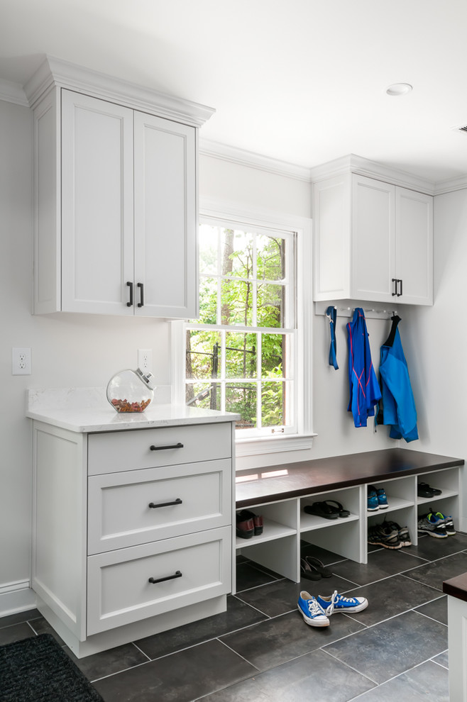 Large transitional gray floor mudroom photo in Atlanta with white walls