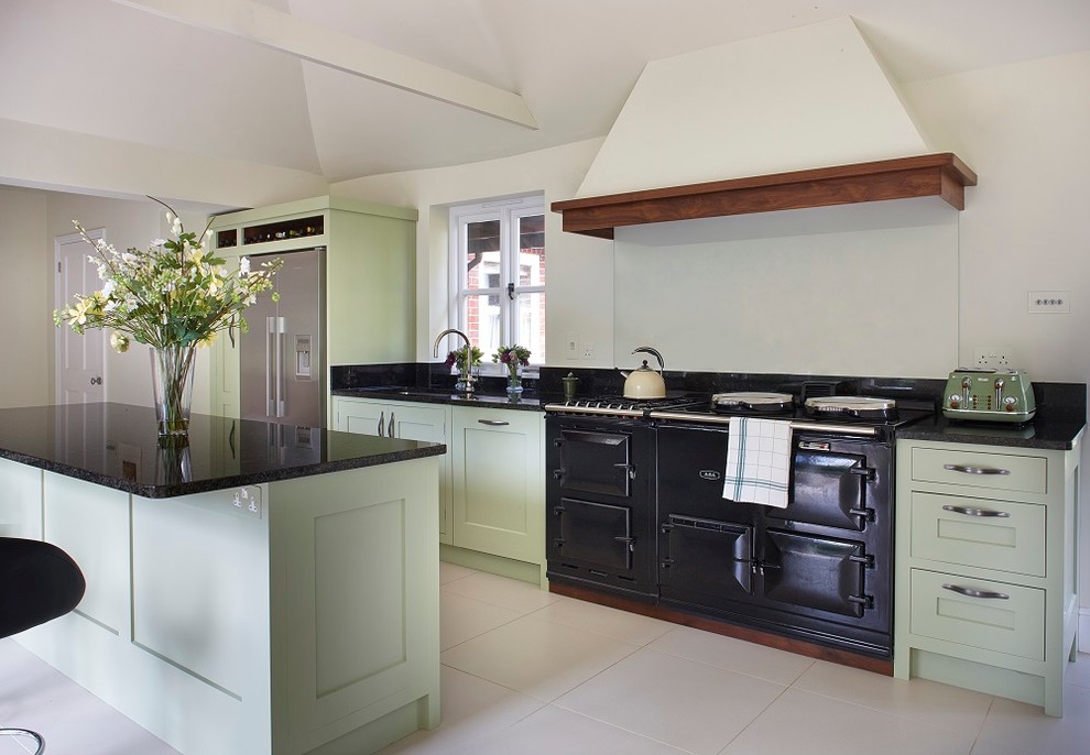 Design ideas for a mid-sized contemporary single-wall eat-in kitchen in Surrey with an undermount sink, shaker cabinets, green cabinets, granite benchtops, black splashback, glass sheet splashback, stainless steel appliances and with island.