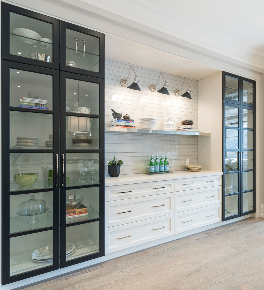 Open concept kitchen - transitional galley beige floor open concept kitchen idea in Toronto with an undermount sink, shaker cabinets, white cabinets, white backsplash, subway tile backsplash, stainless steel appliances and an island