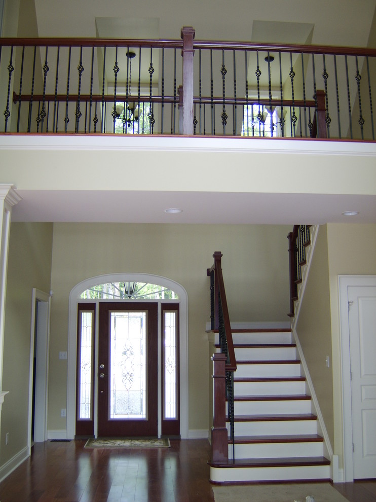 Foyer - mid-sized transitional dark wood floor foyer idea in DC Metro with beige walls and a glass front door