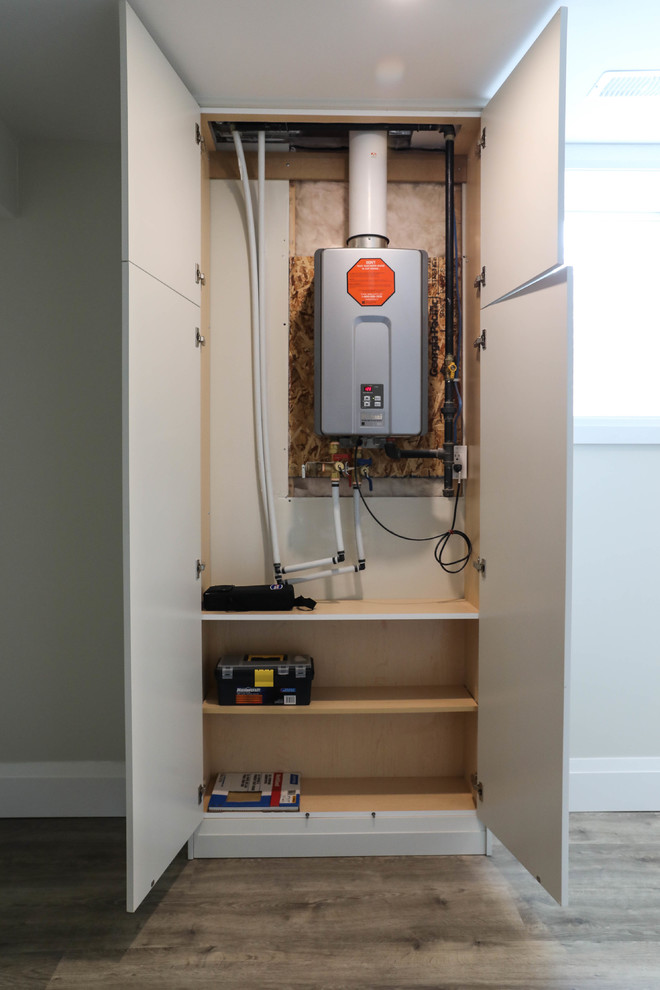 Large transitional look-out vinyl floor and brown floor basement photo with white walls