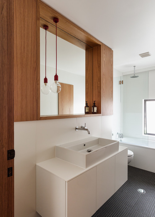 in wall basin mixer in bathroom with timber cabinetry