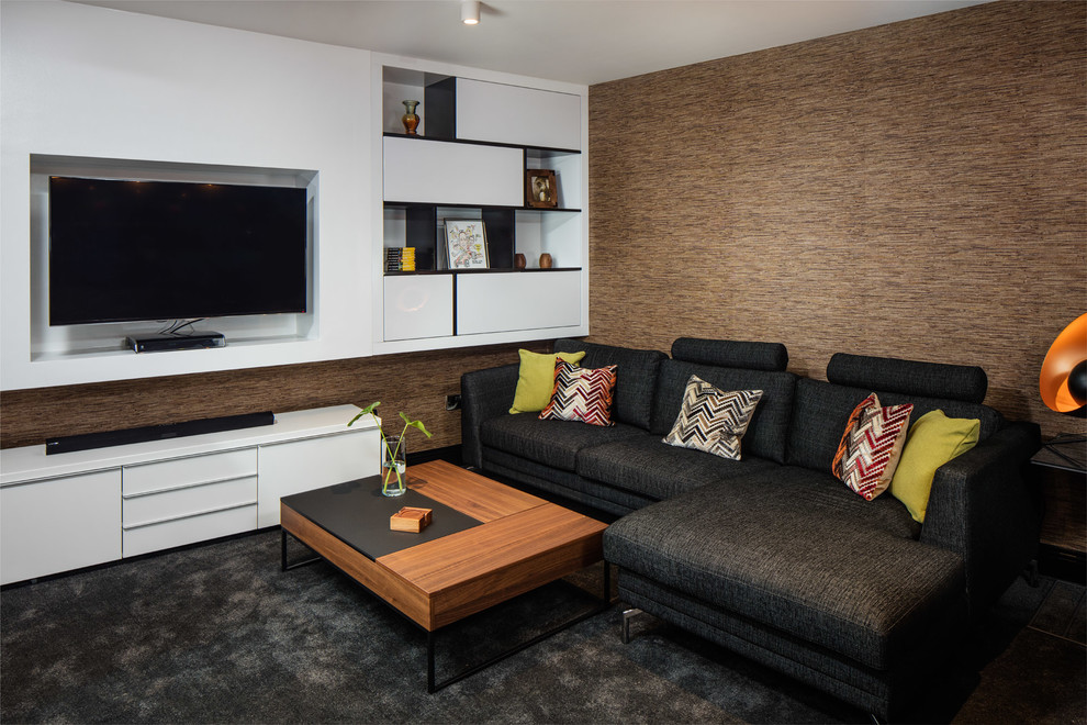 Photo of a mid-sized contemporary open concept living room in Dublin with brown walls, carpet, no fireplace and a wall-mounted tv.
