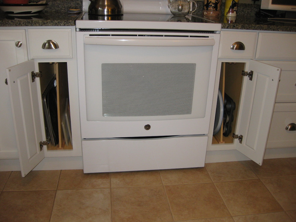 Inspiration for a transitional l-shaped ceramic tile and beige floor kitchen remodel in Boston with an undermount sink, shaker cabinets, white cabinets, granite countertops, white appliances and green countertops