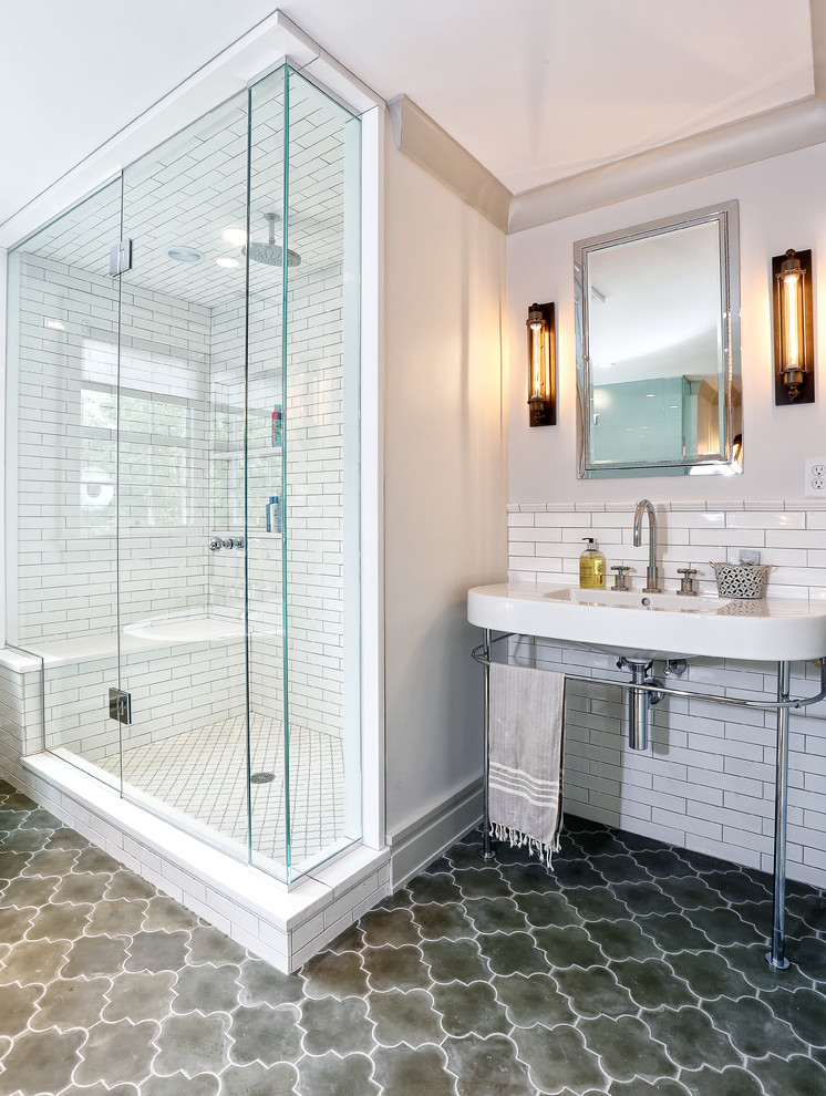 Photo of a transitional bathroom in New York with a console sink and subway tile.