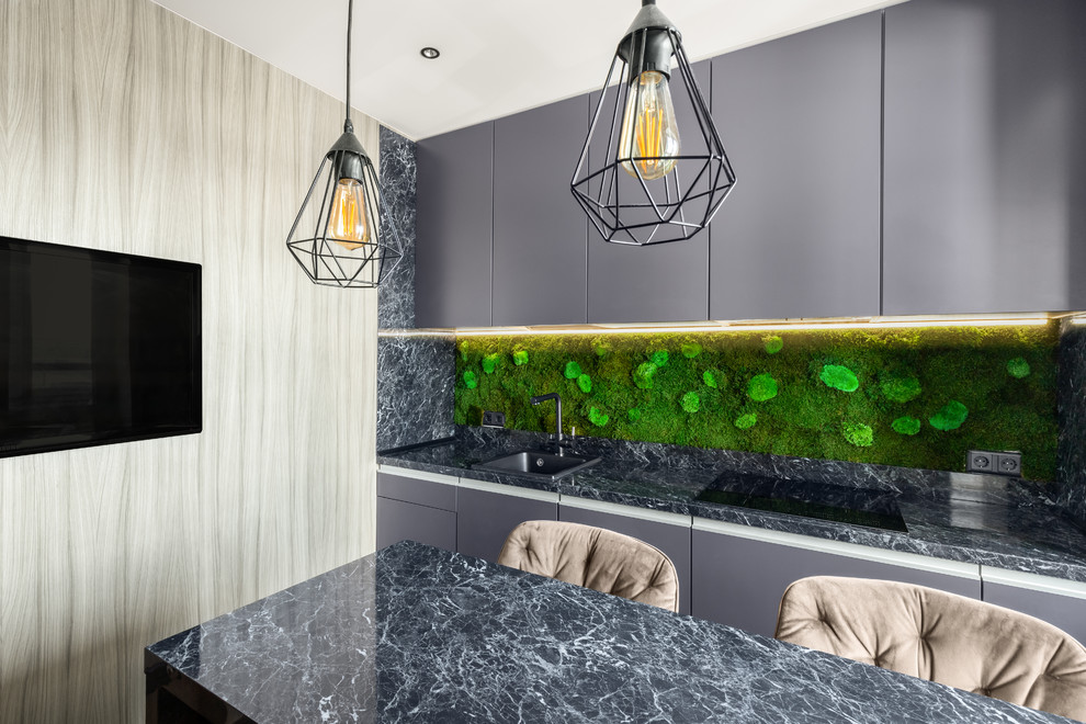 Photo of a contemporary single-wall kitchen in Saint Petersburg with a drop-in sink, flat-panel cabinets, grey cabinets, green splashback, with island and grey benchtop.