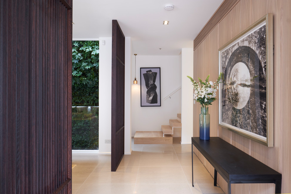 Inspiration for a mid-sized modern hallway in London with white walls and beige floor.