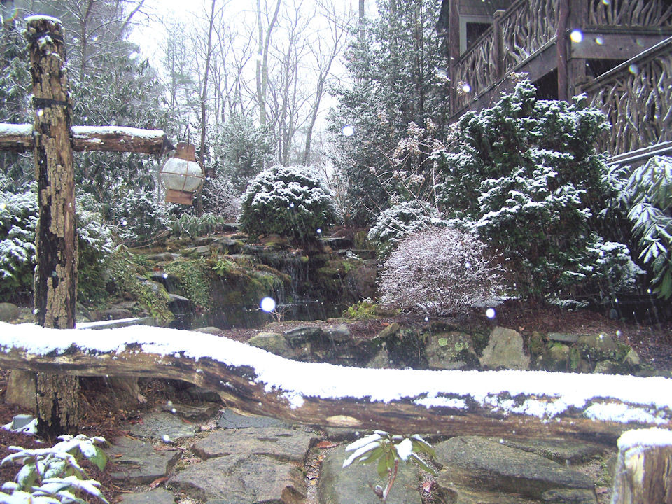 Photo of a traditional partial sun garden for winter in Other with a water feature and natural stone pavers.