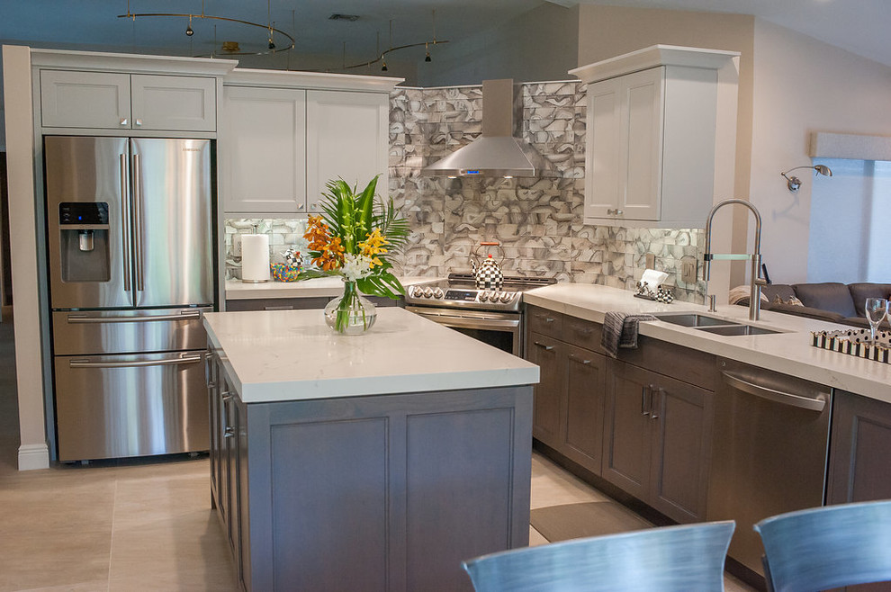 Inspiration for a mid-sized transitional u-shaped porcelain tile and beige floor eat-in kitchen remodel in Miami with an undermount sink, shaker cabinets, gray cabinets, quartz countertops, gray backsplash, glass tile backsplash, stainless steel appliances, an island and white countertops