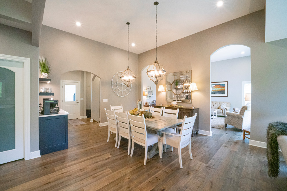 Inspiration for a large transitional medium tone wood floor and gray floor great room remodel with beige walls