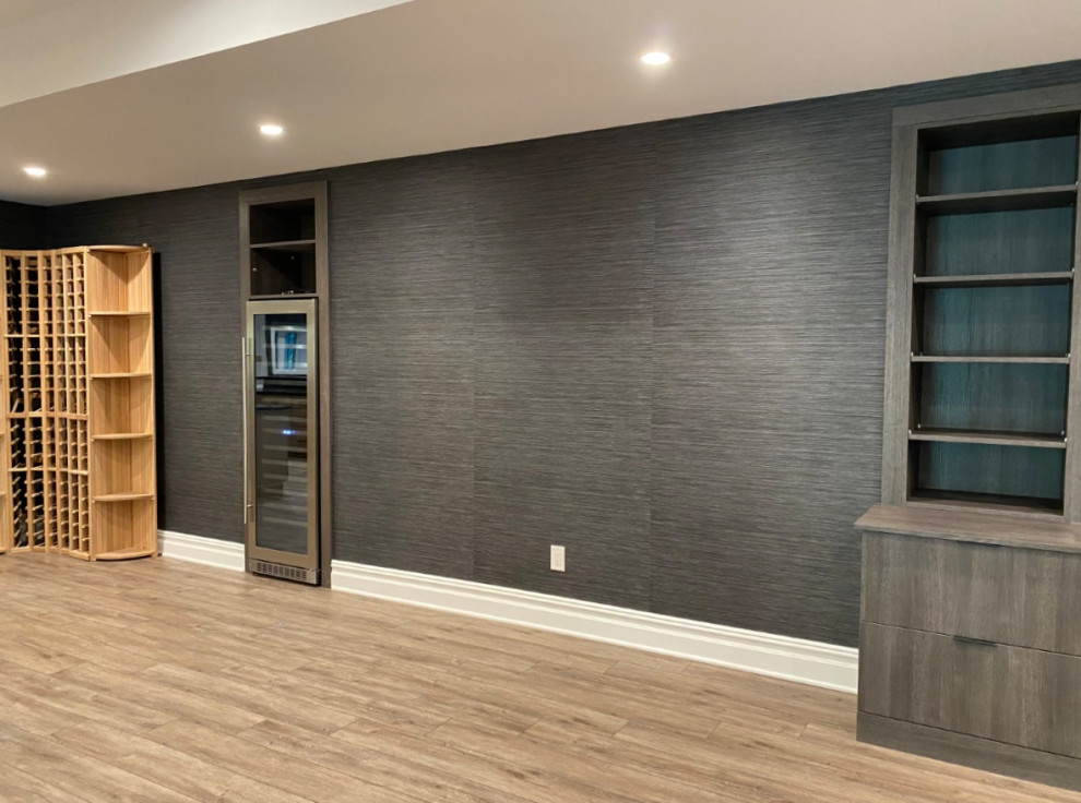 Design ideas for a large contemporary walk-out basement in Newark with a home bar, grey walls, vinyl flooring, no fireplace, beige floors, a drop ceiling and wallpapered walls.